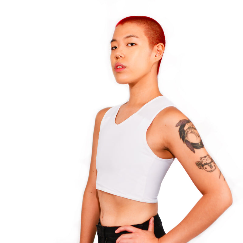 Model showing off the front and side of the white half binder, hand on hip.
